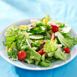 Fresh salad with homegrown lettuce, tomatoes, and peppers.